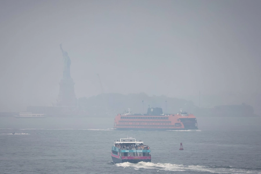 The Statue of Liberty hidden behind smoke from Canadian wildfires on June 30, 2023.